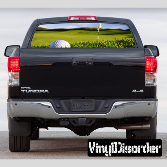 Truck rear window view graphic with golf course and white golf ball