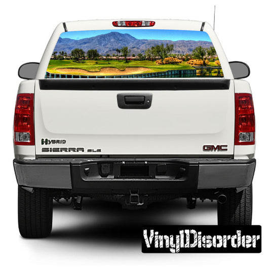 Vehicle rear window view graphic decal on pickup truck, with colorful golf scene