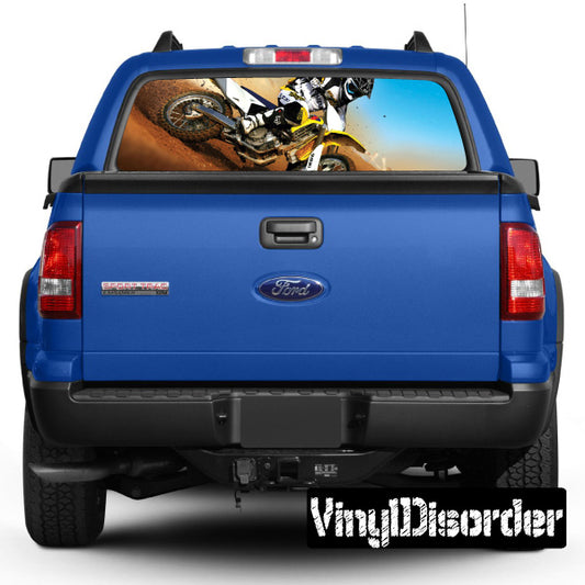 Blue pickup rear window with moto graphic and tailgate centered view