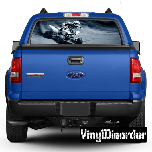 Blue pickup tailgate with rear window graphic showing a sport motorcycle scene