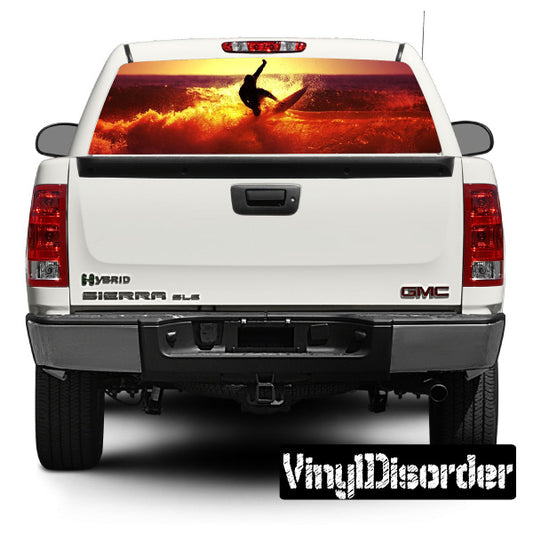 Vehicle rear window graphic decal with surf scene and red sky, on white SUV tailgate