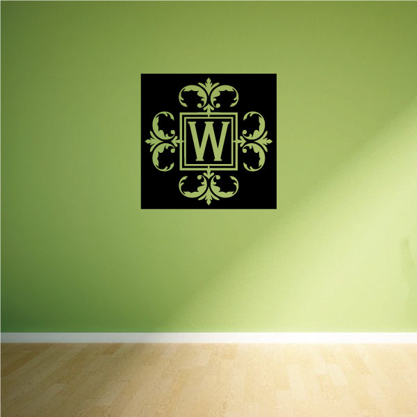 Square monogram decal with ornate gold "W" on a black square