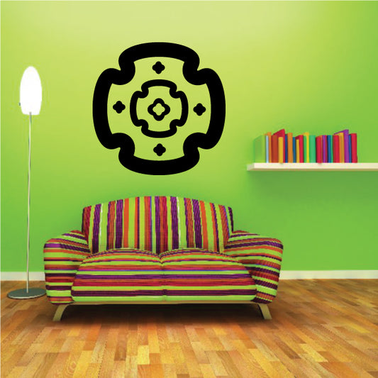Black circular starburst decal with small star accents and inner rosette design.