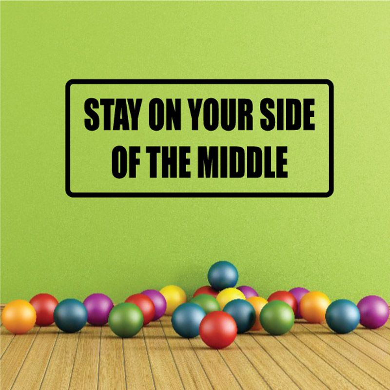 Black-bordered wall decal: 'STAY ON YOUR SIDE OF THE MIDDLE'.