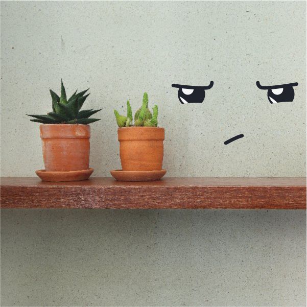 Vinyl wall decal with two cartoon black eyes and small mouth line