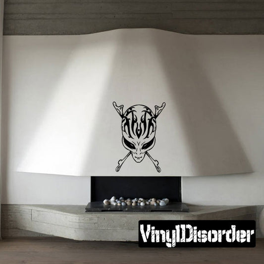 Alien head decal with horns and crossed bone shapes, black line art on light surface
