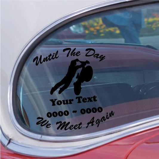 Car window decal with bold black memorial text and two silhouetted riders.