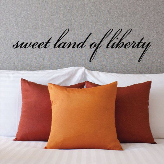 Script wall decal reading “sweet land of liberty” in black cursive letters