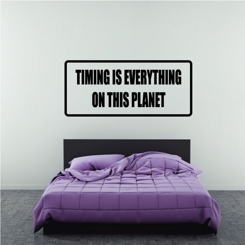 Wall decal with bold text: "Timing is everything on this planet"