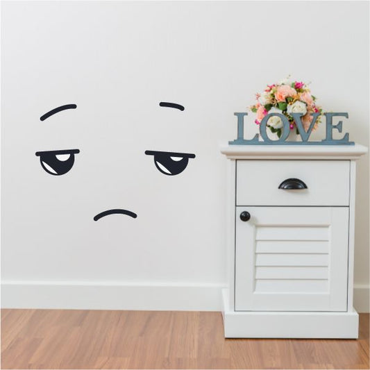 Vinyl wall decal of a tired face emoticon with curved brows and downturned eyes