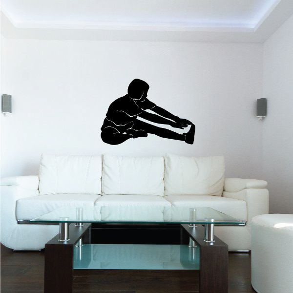 Vinyl wall decal of black toe-reach stretching figure on wall