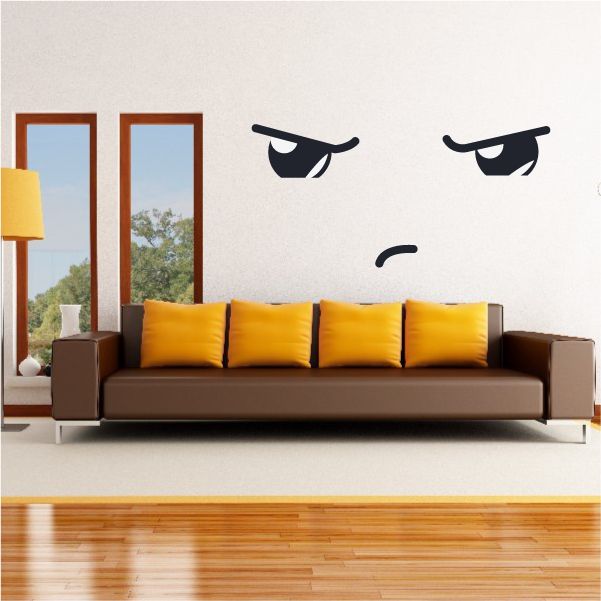 Vinyl face expression wall decal with black angry eyes and small frown