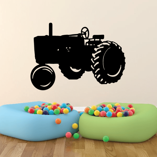 Black tractor decal silhouette for walls, featuring detailed wheel and cab outline
