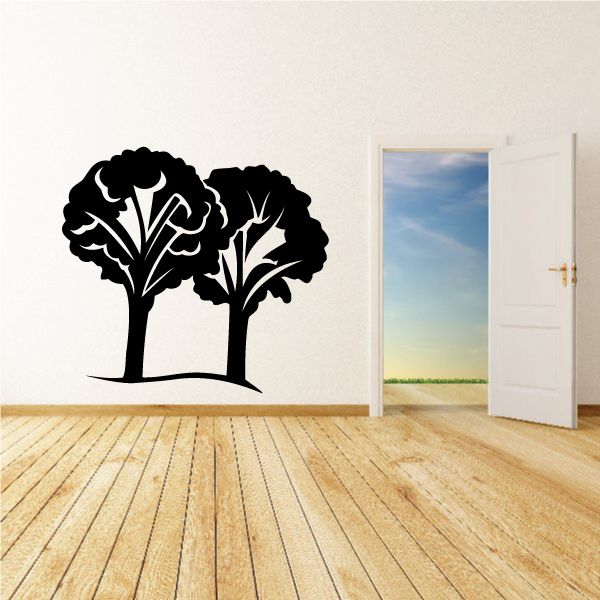 Vinyl tree wall decal with two black stylized tree silhouettes and branches