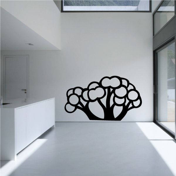 Tree wall decal featuring a black tree silhouette with clustered round leaves