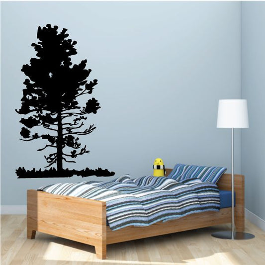 Black vinyl tree wall decal with broad leafy silhouette and roots