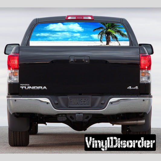 Pickup truck rear window graphic with tropical palm tree and blue sky