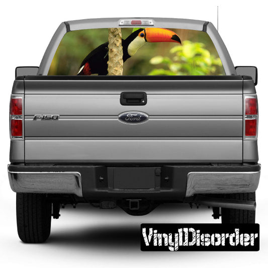 Tropical rear window view decal with toucan bird on pickup truck glass