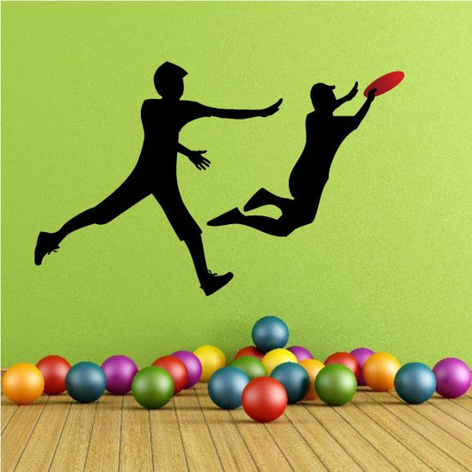 Vinyl wall decal of two boys playing frisbee, black silhouettes with red frisbee