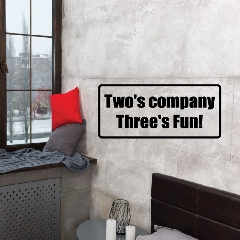 Wall decal with black text reading “Two’s company Three’s fun!”