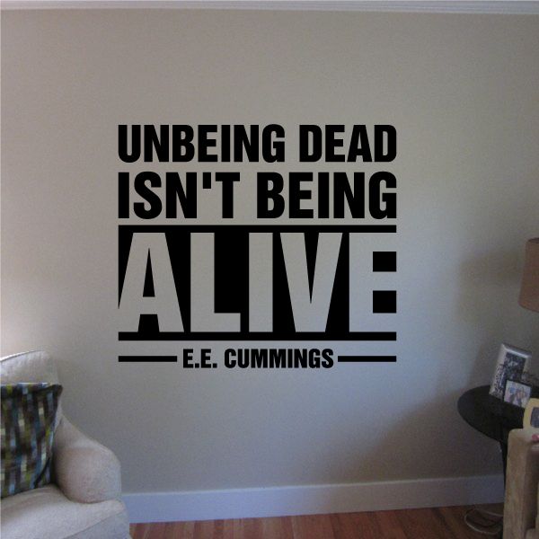 Black typography wall decal reading “UNBEING DEAD ISN’T BEING ALIVE” by E.E. Cummings