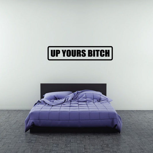 Black-and-white wall decal with bold text: UP YOURS BITCH