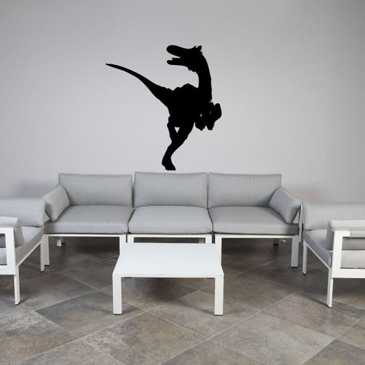 Black velociraptor silhouette wall decal, arched tail and raised claw pose