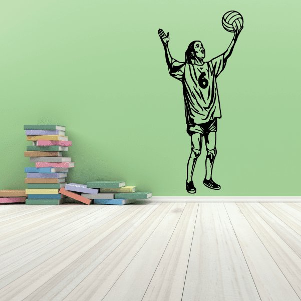 Volleyball player wall decal showing a silhouette with a raised volleyball