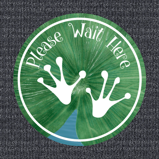 Green circular non-slip floor sticker: 'Please Wait Here' with handprints
