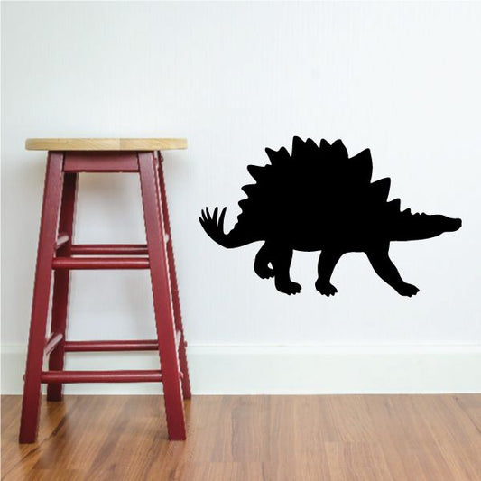 Walking stegosaurus wall decal in black, with spines and tail