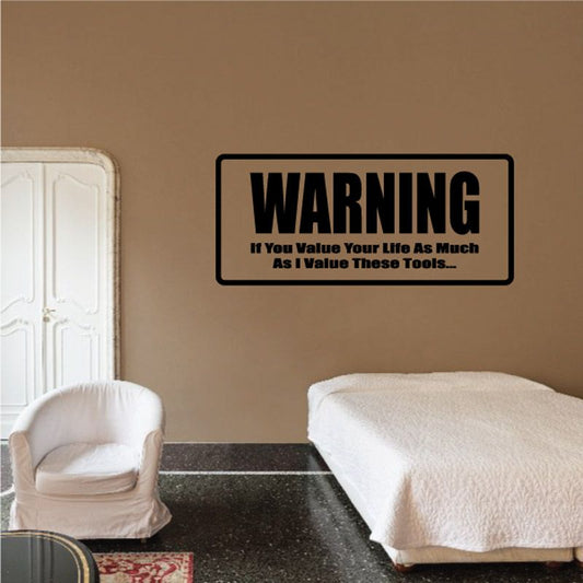 Warning wall decal with black border and bold yellow text: value your life, tools.