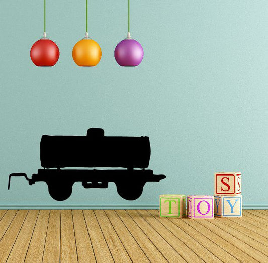 Black water tanker trailer silhouette decal on wooden surface with small letter blocks