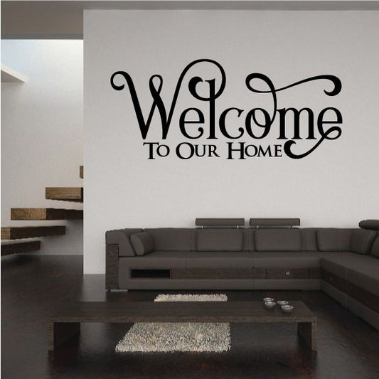 Wall decal reading “Welcome To Our Home” in black swirly script