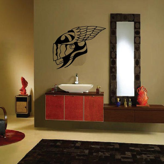 Winged helmet dirt bike decal with black and white stylized face and wings