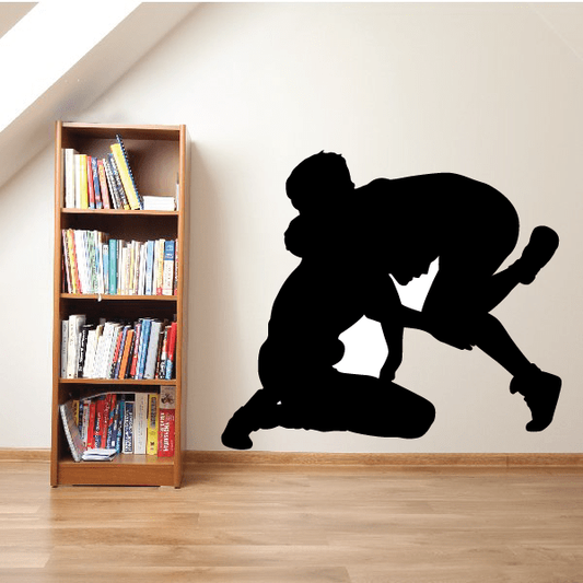 Wrestling wall decal: black vinyl silhouette of a wrestler in a kneeling grappling pose