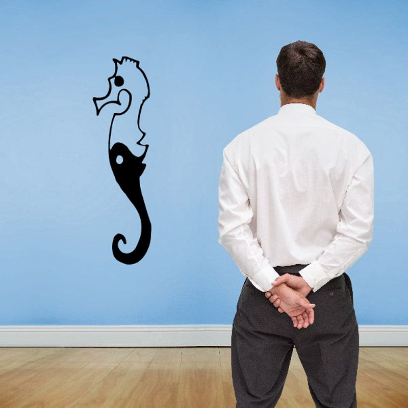 Yin yang seahorse decal with black outlines and yin-yang swirl on wall