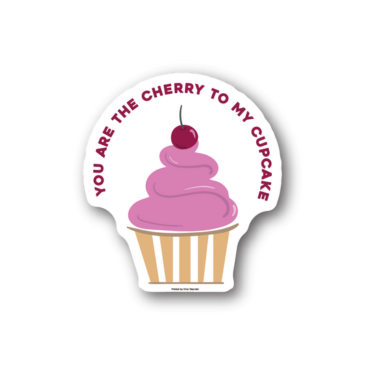 Vinyl sticker with pink cupcake and cherry topper, striped wrapper, circular text border.