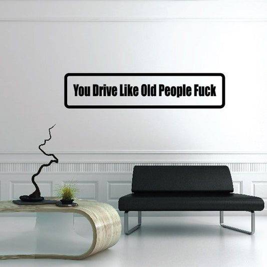 Black vinyl decal with bold white text 'You Drive Like Old People Fuck'