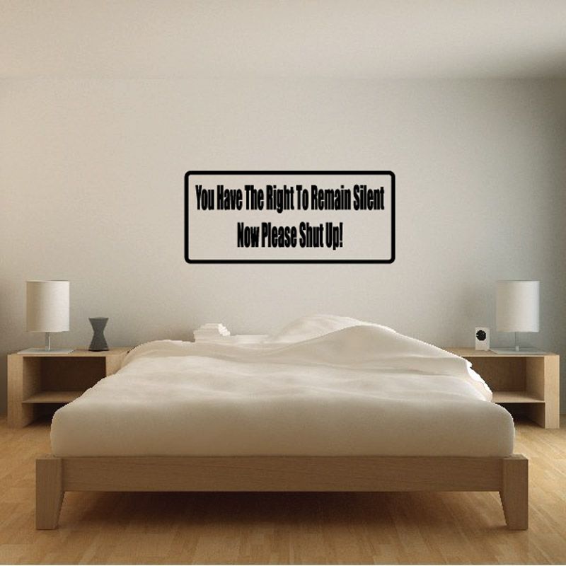 Rectangular wall decal with black border and text: 'You have the right to remain silent'