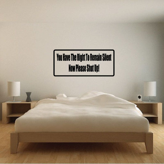 Rectangular wall decal with black border and text: 'You have the right to remain silent'