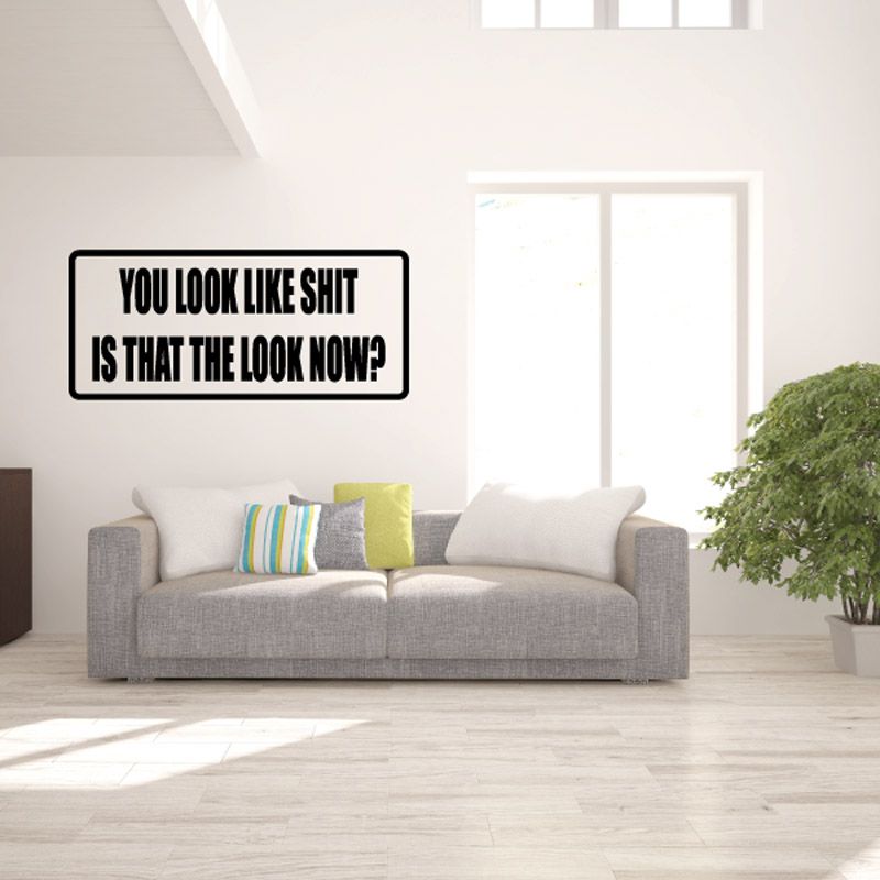 Black-bordered wall decal with bold white text: “YOU LOOK LIKE SHIT”