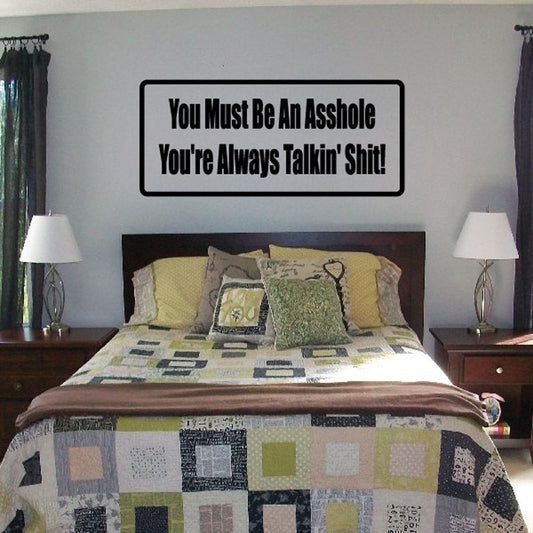 Black vinyl wall decal reading “You Must Be An Asshole” and “You’re Always Talkin’ Shit!”