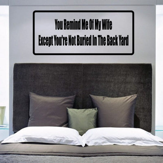 Rectangular wall decal with black border and white text reading 'You Remind Me Of My Wife'.