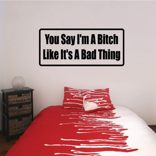 Black wall decal with bold yellow and white quote text: “You Say I'm A Bitch”