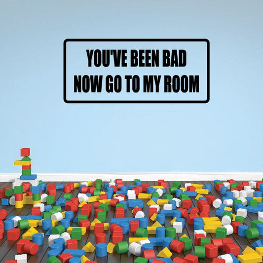 Wall decal sign with bold black border and yellow/white text: YOU'VE BEEN BAD