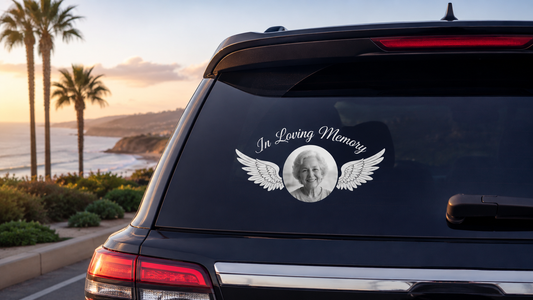 Custom In Loving Memory photo decal with angel wings on a rear vehicle window by the coast
