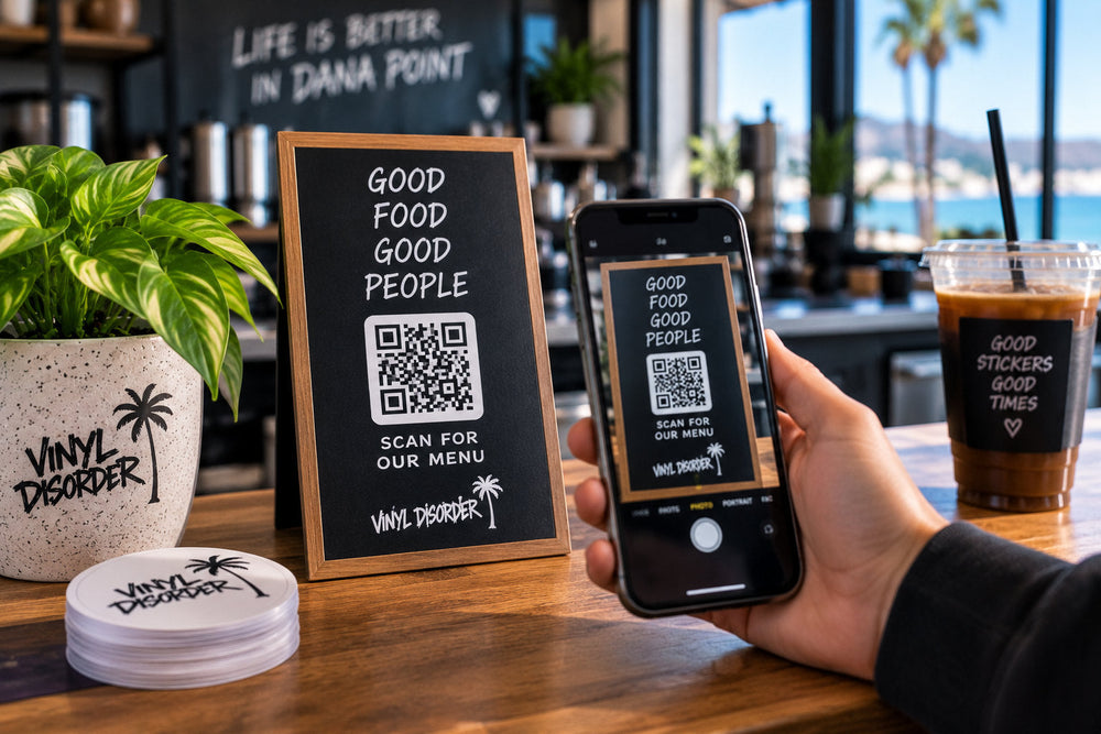 Customer scanning a Vinyl Disorder QR code menu sign at a coastal cafe counter