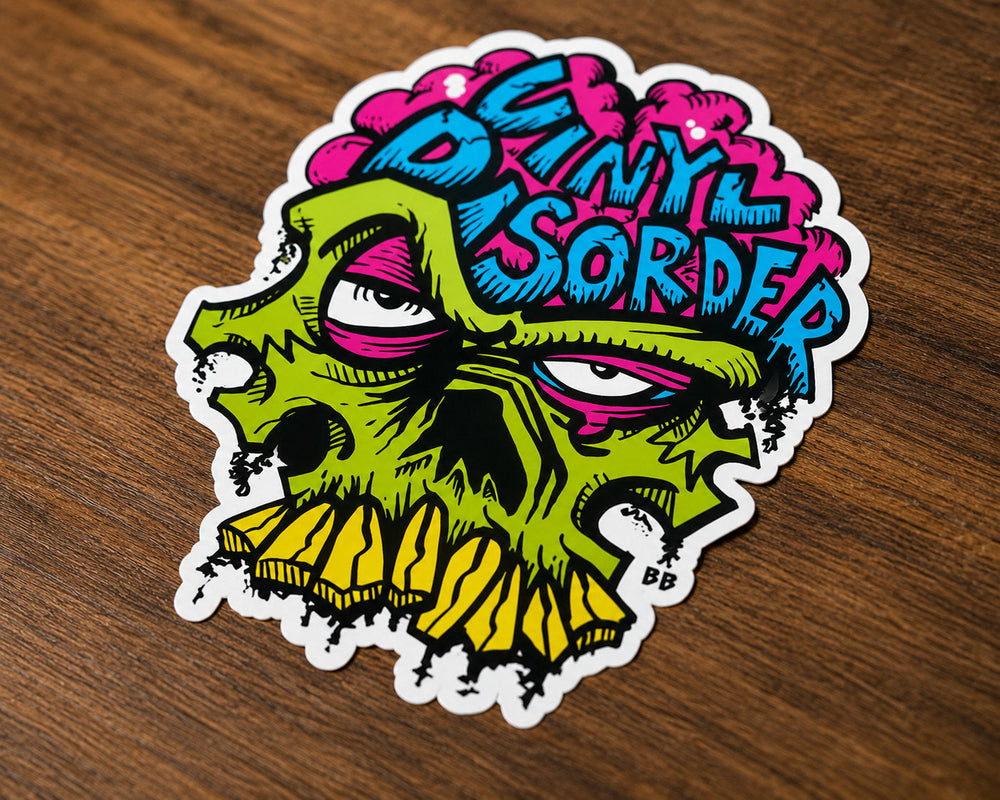 Colorful Vinyl Disorder sticker with a clean white border on a wooden tabletop