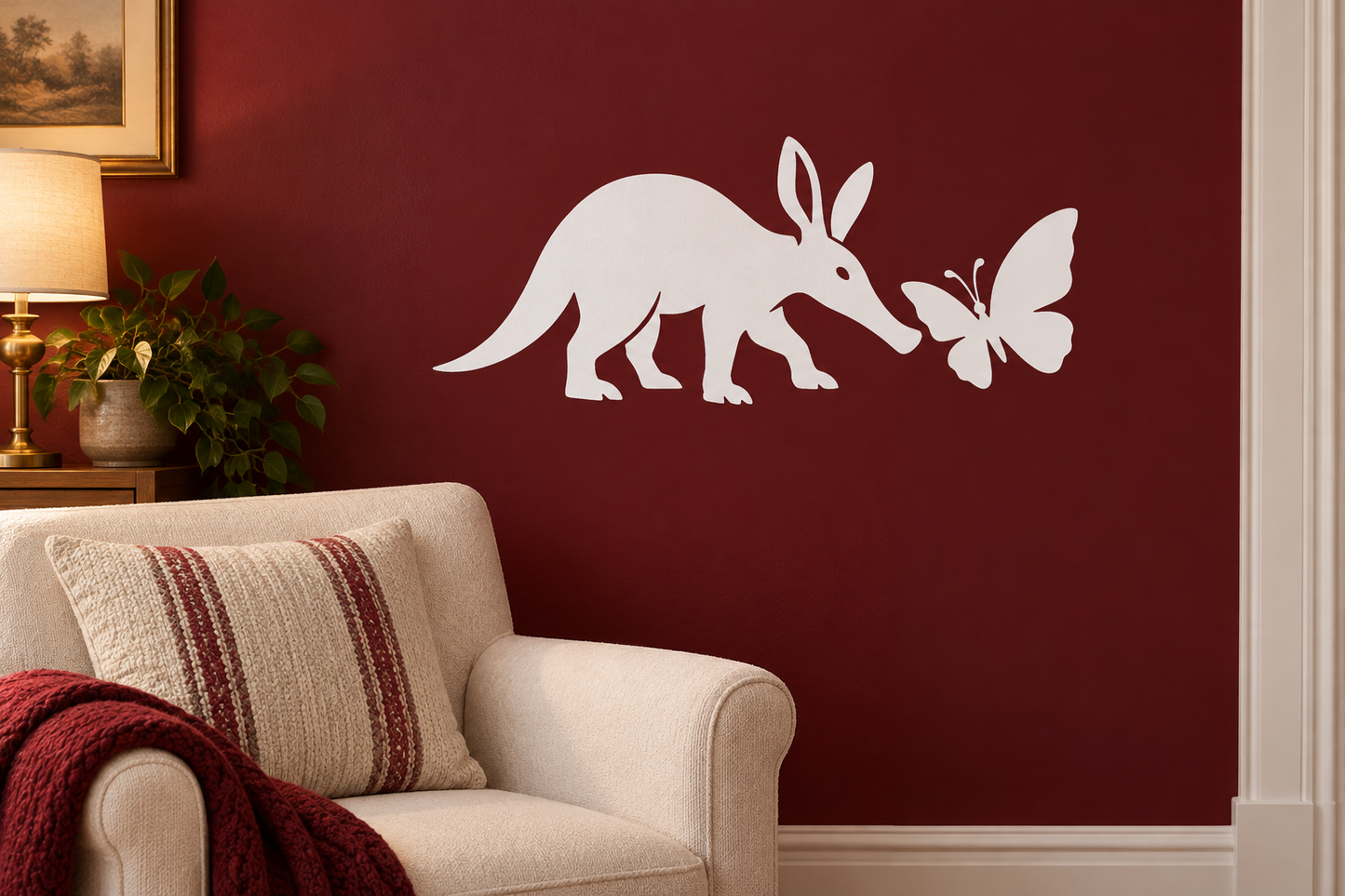 White vinyl decal of a standing aardvark with a butterfly and small insect accents