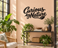 Curious by Nature vinyl wall decal in black cursive lettering